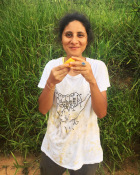 Luiza eating a mango