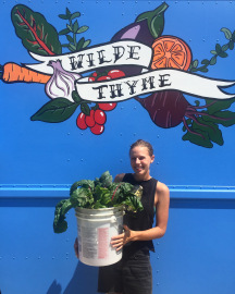 Emma delivering chard to the truck from her garden last summer.